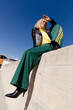 © Tania Cervian/Stocksy - Woman sitting against blue sky