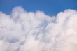 © Sonja Lekovic/Stocksy - Fluffy white clouds and blue sky background