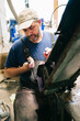 © Daniel Gonzalez/Stocksy - Craftsman sharpening knife blade on grinding machine
