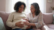 © AIMIN - Mother's Day pregnant daughter expectant mom grandmother touching belly together celebrating motherhood love support family bond generational connection warmth hope joy background