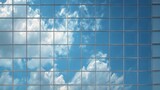 Glass panels reflecting sky repeating pattern