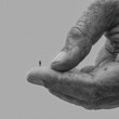 © Siriroj - Person on giant hand symbolizing support, dominance
