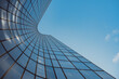 © yaqui_villegas - Minimal upward view of modern architecture as glass office skyscraper building facade shows reflection in Paris France with blue sky clean lines and copy space