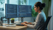 © Rukhasana - A focused young Indian female programmer is intently typing on a keyboard, working on complex code displayed across dual monitors in a modern office setup.