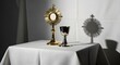 © Afif - Corpus Christi ritual setup with gold monstrance and chalice on white tablecloth indoors