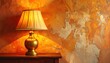 © Matthew - Gold lamp on wooden table casts warm glow on textured wall with orange and beige tones