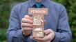 © Onetrick  - Concept of pension and retirement. Business person holding wooden blocks with icons sees the text PENSION.