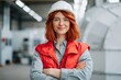 © Andrii Zastrozhnov - Young engineer smiling with arms crossed in factory interior