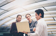 © nuttawutnuy - Portrait of Business team meeting on blurred city background. Business success and brainstorm concept.