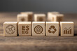© Khurshida art house - ESG strategy concept. wooden blocks showing environmental social and governance icons, target symbol. measurable sustainability goals, corporate responsibility planning. long-term business performance