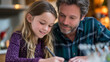 © Maksym - Over the shoulder view of father helping elementary daughter with science project on kitchen table, warm indoor available light, focused and supportive