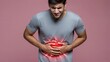© olga_demina - A man experiencing stomach pain, clutching his abdomen in distress