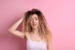© New Africa - Unhappy woman with tangled hair on pink background