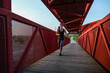 © FotoAndalucia - woman running on red bridge