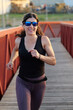 © FotoAndalucia - woman with sunglasses running on a bridge