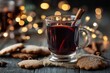 © Leo - Cozy mulled beverage in glass mug, cinnamon, orange, gingerbread, anise, golden bokeh lights
