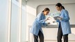 © Tuwaeteemoh - Asian Women Scientists Comparing Traditional Petri Dish with AI Tablet Scan