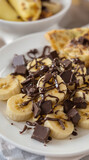 girl dinner banana chocolate snack plate with caramel drizzle and crushed nuts on marble table