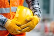 © SaidahNafisah - close up of worker wearing protective helmet gloves and safety vest, construction safety concept, clean background, professional look , building safety week