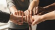 © Karya - Diverse group of people engaging in a fist bump to celebrate teamwork in a bright room