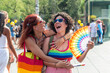 © AlvaroRT - Happy women embracing enjoying a pride parade event