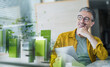 © Westend61 - Smiling businessman with tablet in modern setting and green energy concept
