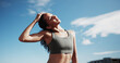 © peopleimages.com - Fitness, city and woman stretching neck for exercise, training and warm up for workout with blue sky. Sports, runner and person getting ready for wellness, health or mobility for active hobby in town