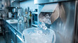 © VectorVille - Ice machine dispensing ice cubes into clear plastic bucket in kitchen