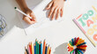 © Volha - Child drawing with colorful pencils creative play and learning concept
