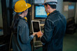 © Wanwajee - Two industrial workers reviewing machine performance on tablet in factory setting. Production monitoring and digital inspection concept with engineering teamwork and automation system integration.