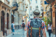 © Raquel - A man with a large backpack and a straw hat walks down a blurred old town street, exploring urban architecture and local culture during a summer vacation journey through famous European destinations.