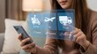 © SRD - Woman selects logistics delivery options on a transparent digital screen while using her smartphone in a comfortable home setting.