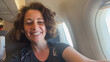 © Юлия Завалишина - Happy passenger young woman is flying in plane. Smiling girl sitting in airplane near window going on trip vacation travel. Traveling female inside plane enjoying flight. Traveling girl