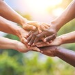 © yanti - Diverse hands stacked together in unity outdoors