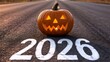 © Ali - Glowing jack o lantern pumpkin sitting on asphalt road marked with 2026 for halloween celebration concept and future new year festive holiday seasonal greeting