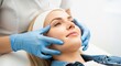 © siam - Professional cosmetologist performing a facial massage on a young woman in a beauty clinic