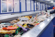 © Parilov - Recycling facility conveyor belt with mixed plastics and waste materials