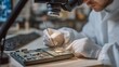 © Tania - A red team analyst in a university research lab connects a hardware implant to a circuit board under a magnifying arm lamp, detailed close-up of gloved fingers and fine-tip soldering tools, ideal