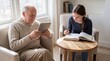 © ryker - Elderly man and teenage girl sitting in living room, grandfather reading tablet while granddaughter studies from open book at wooden table, warm natural light and quiet focused moment