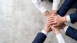 © ryker - Business team stacking hands in unity and cooperation, top down birds eye view showing teamwork and professional collaboration