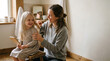 © TCyamauti - Mother and daughter brushing hair together, tender moment