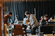 © qunica.com - Students gather around a foosball table while others play board games at tables nearby. A relaxed indoor recreation space shows young people socializing and enjoying tabletop games.