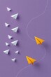 © Iryna - Orange paper planes turning away from formation on purple background