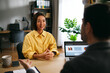 © djile - Confident businesswoman smiling during successful business meeting