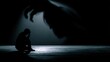 © ramang - Silhouette of a person in despair under a looming shadow.
