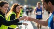 © Elenba - Smiling volunteers handing water to runners during marathon race