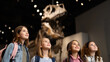 © sabyna75 - Group of diverse young girls fascinated by dinosaur exhibit in museum