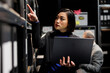 © DC Studio - Asian private investigator in criminal cases archival depository office looking for criminal case paperwork on cabinet shelves. Detective surrounded by criminology file folders in agency cabinet room