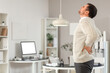 © Pixel-Shot - Young businessman suffering from lumbar pain in office