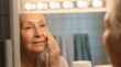 © Vong-7432 - Senior Woman Applying Moisturizing Cream to Her Face